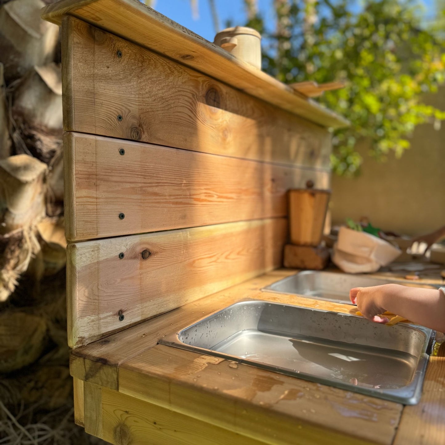 Child cooking in a mud kitchen