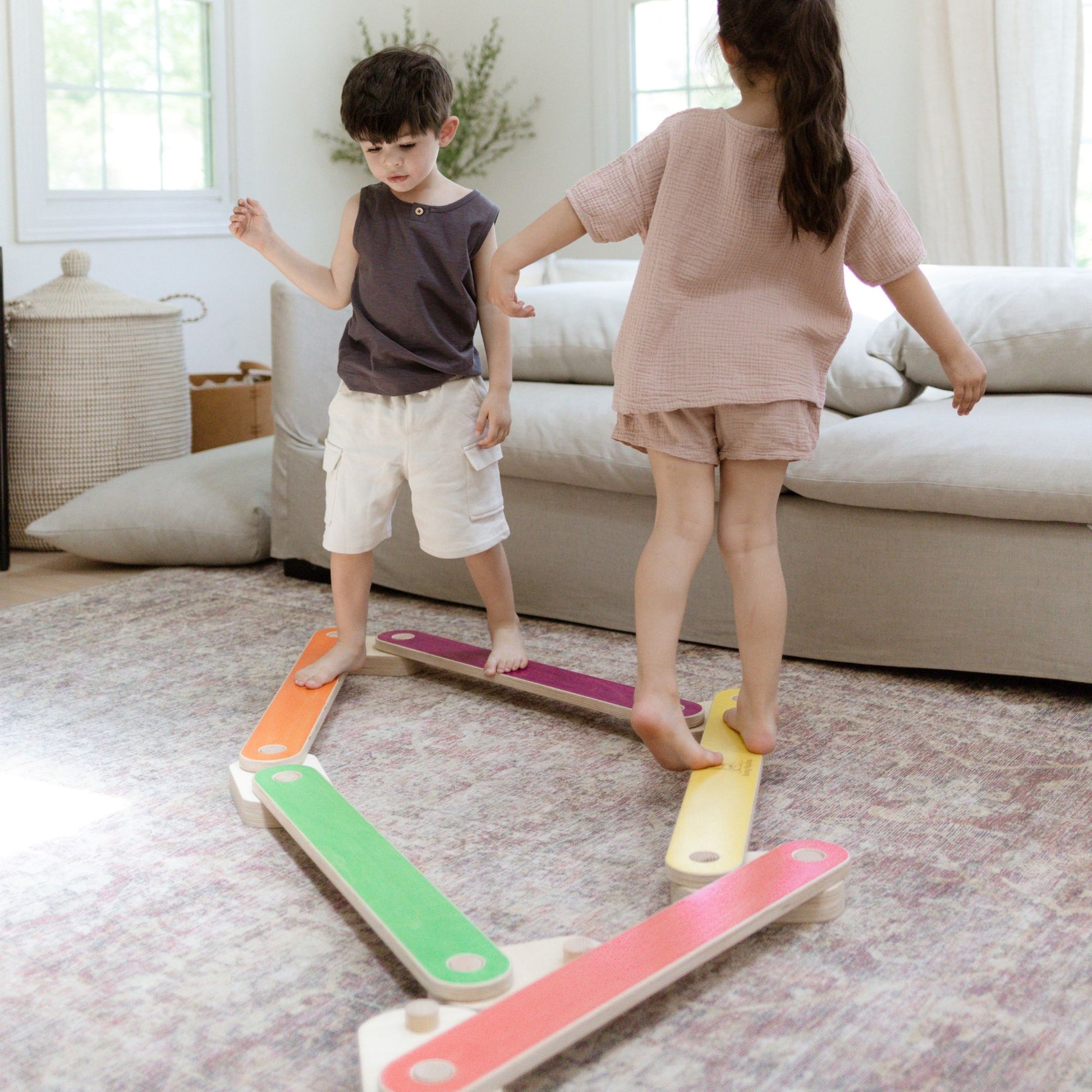 Child balancing on a wooden balance beam