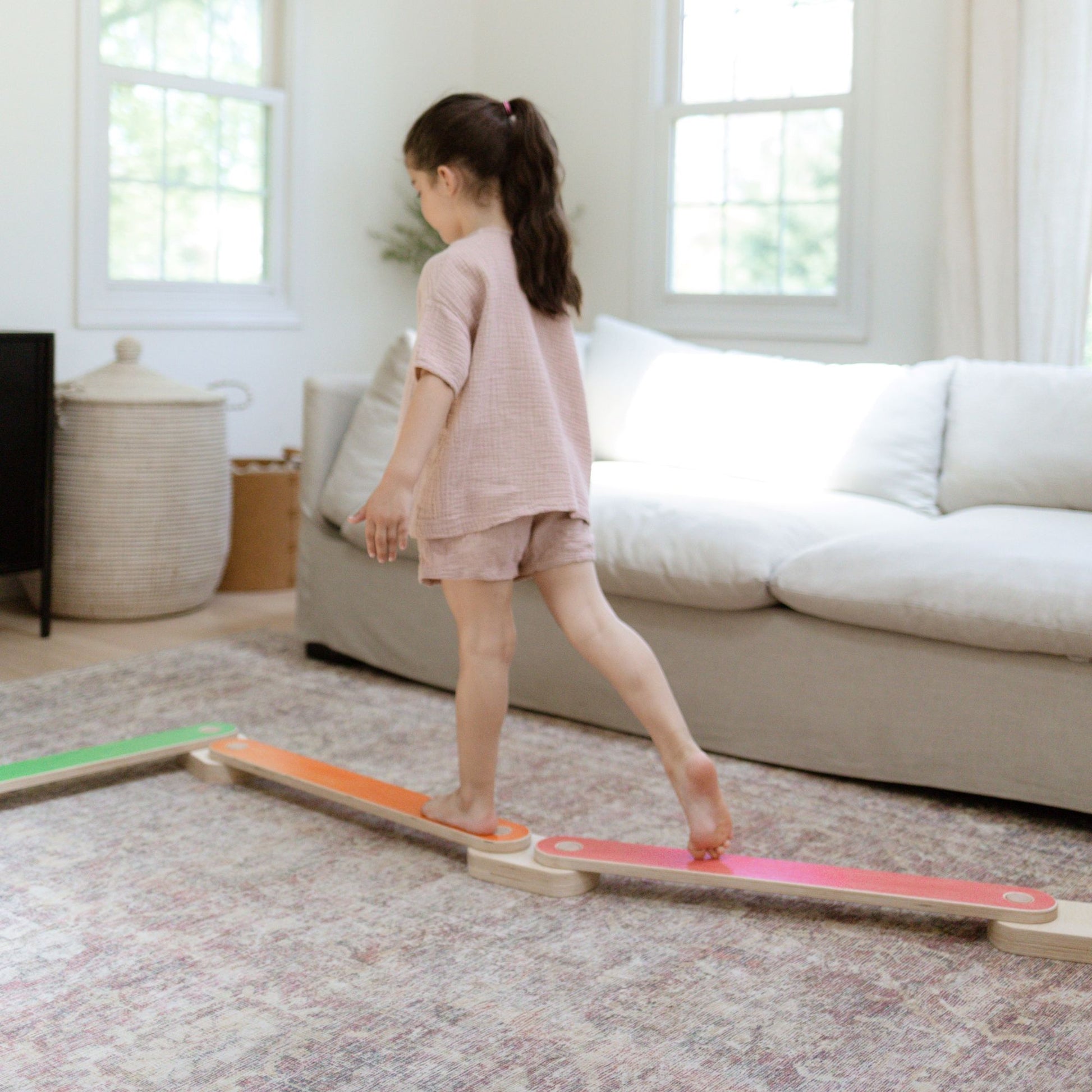Child stepping carefully on a balance beam