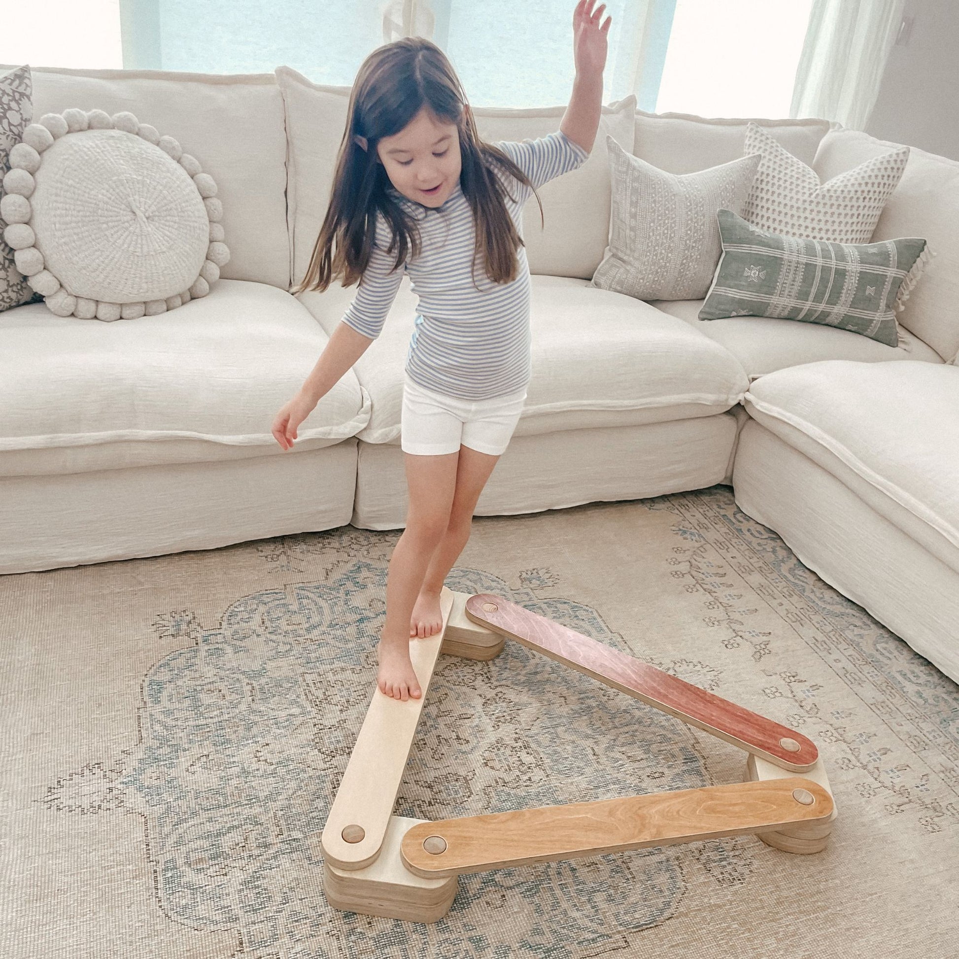 Toddler practicing balance on a beam