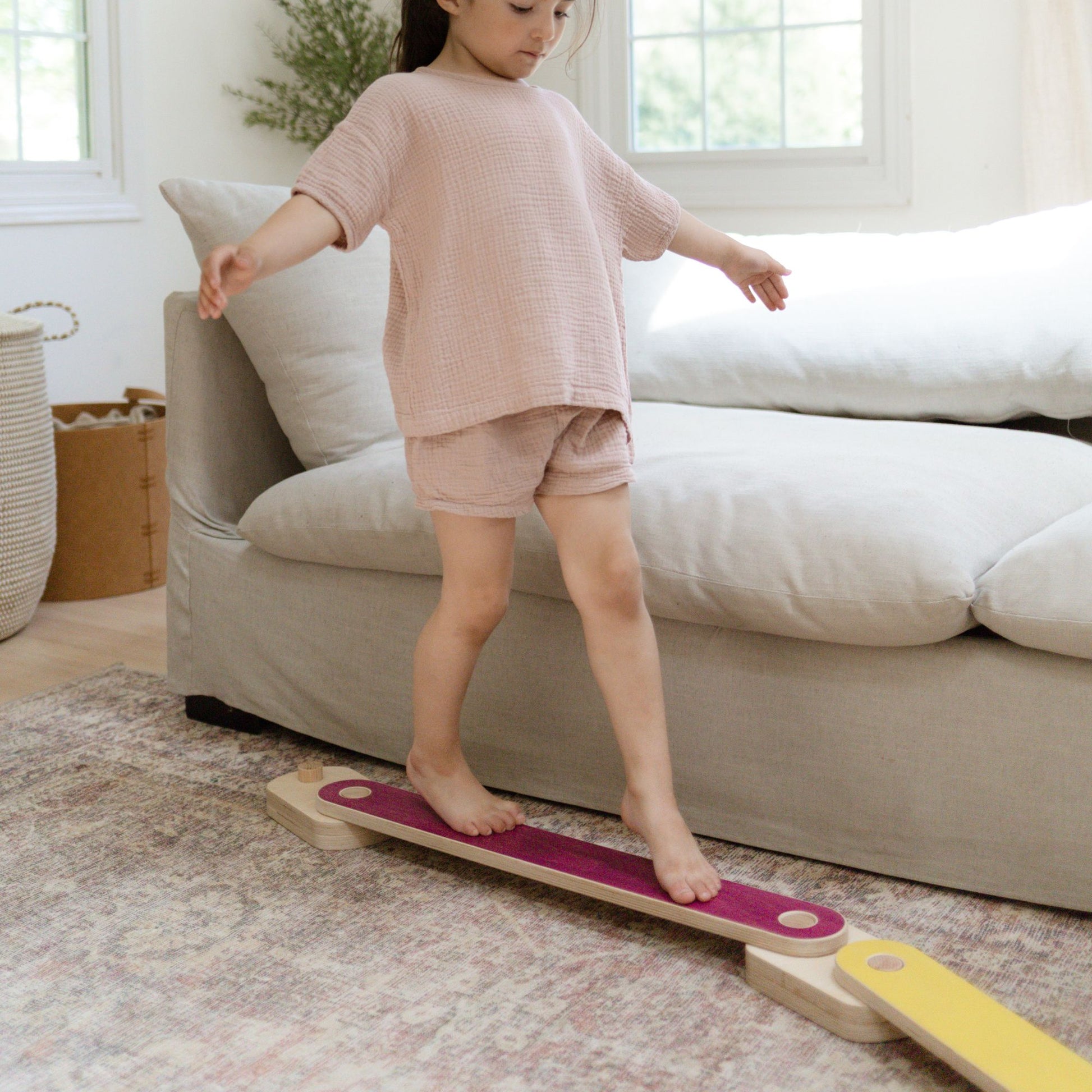 Child developing motor skills with a balance beam