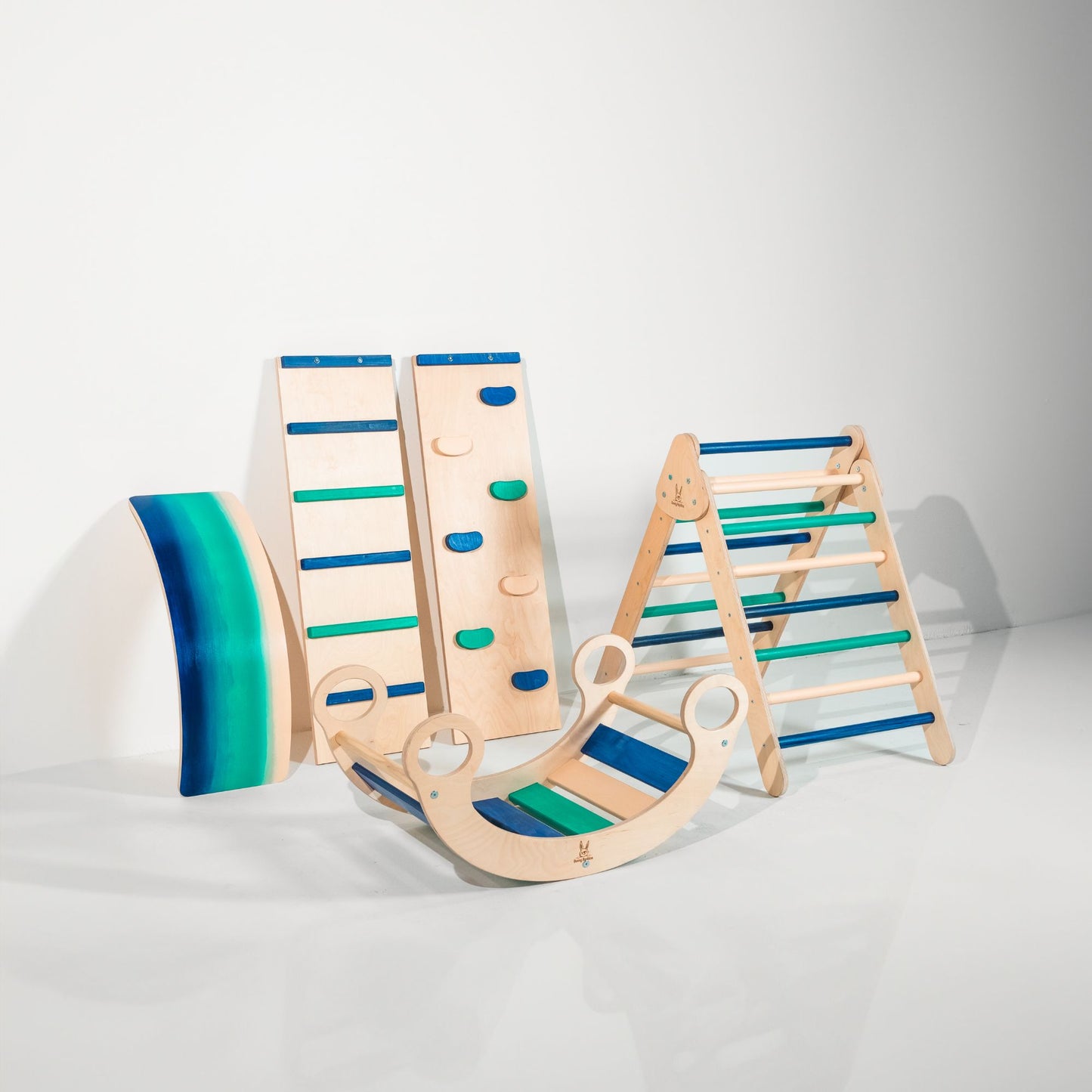 Kids playing on a rocker climber arch indoors