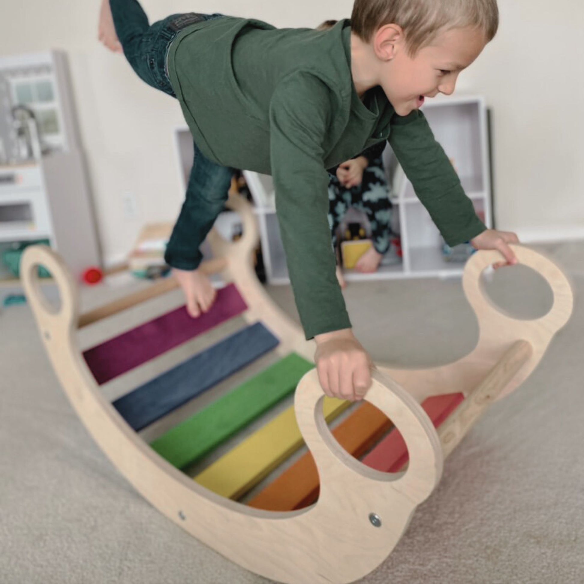 Child climbing on a rocker climber arch