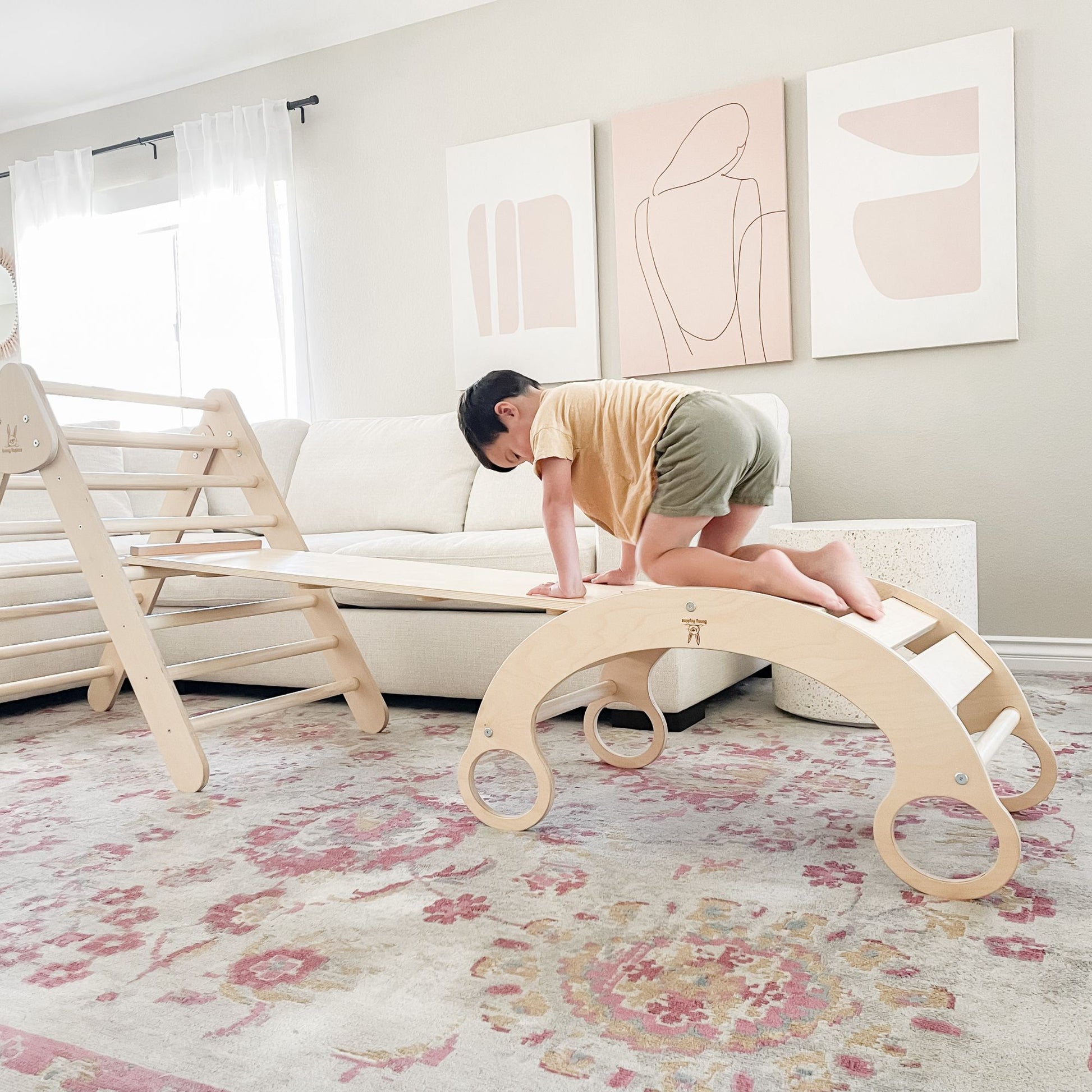 Kids using a rocker climber arch