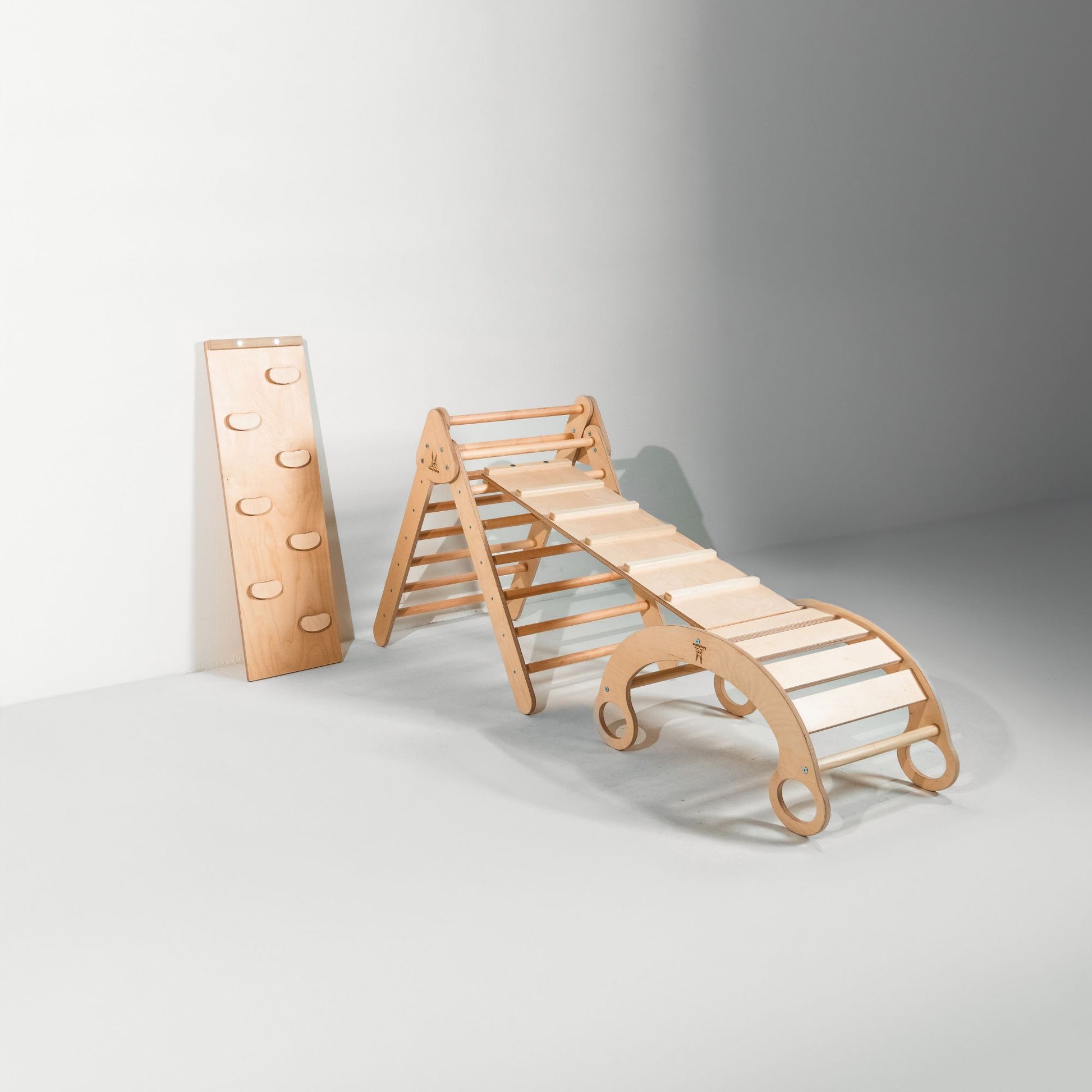 Kids using a versatile rocker climber arch